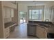 Well-lit kitchen with stainless steel appliances, tile floors, and a view to the outside at 11520 Lounds Ct, New Port Richey, FL 34654