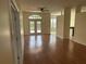 Living room featuring hardwood floors, ceiling fan, and double doors leading to the outdoors at 11520 Lounds Ct, New Port Richey, FL 34654