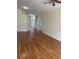 Bright living room with hardwood floors, neutral walls, and an open floor plan at 11520 Lounds Ct, New Port Richey, FL 34654