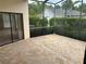 Tiled screened patio overlooking the backyard, perfect for outdoor relaxing at 11520 Lounds Ct, New Port Richey, FL 34654