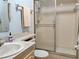 Bathroom featuring a tiled shower with glass doors and a single sink vanity at 11733 Bayonet Ln, New Port Richey, FL 34654