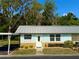Charming single-story home with a light blue exterior, cozy front yard, and covered parking, creating a welcoming curb appeal at 11733 Bayonet Ln, New Port Richey, FL 34654