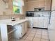 This kitchen has white appliances, ample storage, a microwave, and a practical countertop for quick meals or food prep at 11733 Bayonet Ln, New Port Richey, FL 34654