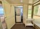 Compact laundry area featuring a washer and dryer, with an adjacent view of the backyard at 11733 Bayonet Ln, New Port Richey, FL 34654