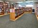 Explore the community library, featuring expansive bookshelves filled with a wide selection of reading materials at 11733 Bayonet Ln, New Port Richey, FL 34654