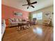Bright and airy living room features a ceiling fan and light walls, creating a cozy, inviting space for relaxation and entertainment at 11733 Bayonet Ln, New Port Richey, FL 34654