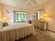 Spacious main bedroom offering peaceful retreats, with light walls, large window, and stylish furnishings at 11733 Bayonet Ln, New Port Richey, FL 34654