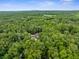 An aerial shot showcasing the home's secluded location surrounded by lush, mature trees at 12085 Stringer Rd, Brooksville, FL 34601