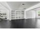 Large basement with built-in shelves, black tile flooring, and recessed lighting at 12085 Stringer Rd, Brooksville, FL 34601
