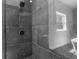 Modern bathroom features sleek glass enclosed shower with dark tile surround and rainfall shower head at 12085 Stringer Rd, Brooksville, FL 34601