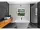 Sleek bathroom featuring a freestanding tub, stylish vanity, and luxurious glass shower enclosure at 12085 Stringer Rd, Brooksville, FL 34601