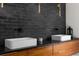 Double vanity bathroom with modern lighting fixtures and two rectangular sinks with black faucet hardware at 12085 Stringer Rd, Brooksville, FL 34601