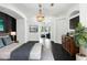 Spacious bedroom with chandelier lighting, dark flooring and an open doorway to a seating area at 12085 Stringer Rd, Brooksville, FL 34601