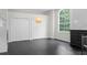 A neutral bedroom with a large window, two closets, dark floors, and a modern light fixture at 12085 Stringer Rd, Brooksville, FL 34601