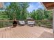 A spacious wooden deck featuring an outdoor seating area and a view of the surrounding greenery at 12085 Stringer Rd, Brooksville, FL 34601