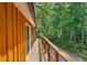 Second story deck off the side of the home, with views of the surrounding landscape and foliage at 12085 Stringer Rd, Brooksville, FL 34601