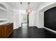 Elegant dining room with black accent wall, decorative chandelier, and unique cabinet at 12085 Stringer Rd, Brooksville, FL 34601