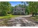 A charming home featuring a two-story exterior elevation, a front yard and luscious surrounding trees at 12085 Stringer Rd, Brooksville, FL 34601