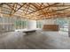Open unfinished interior featuring exposed beams, natural light, and a spacious layout at 12085 Stringer Rd, Brooksville, FL 34601