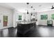 Modern kitchen with large island, white cabinets, and black accents at 12085 Stringer Rd, Brooksville, FL 34601