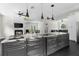 Open-concept kitchen with center island, fireplace, and access to living areas at 12085 Stringer Rd, Brooksville, FL 34601