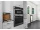Contemporary kitchen with built-in oven, microwave, and stylish cabinetry at 12085 Stringer Rd, Brooksville, FL 34601