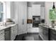 A sleek kitchen featuring stainless steel appliances, stone countertops, an island, and custom cabinetry at 12085 Stringer Rd, Brooksville, FL 34601