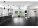 Open-concept living area featuring black tile flooring, a fireplace, and adjacent modern kitchen at 12085 Stringer Rd, Brooksville, FL 34601