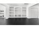 Spacious living room featuring custom built-in shelving and black tile flooring at 12085 Stringer Rd, Brooksville, FL 34601