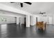 Spacious living room with dark wood floors and ample natural light for entertaining at 12085 Stringer Rd, Brooksville, FL 34601