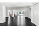Spacious living room with open floor plan, built-in shelving, and black tile flooring at 12085 Stringer Rd, Brooksville, FL 34601