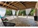Inviting outdoor patio with exposed wood beam ceiling, elegant curtains, and stylish pavers at 12085 Stringer Rd, Brooksville, FL 34601