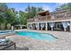 Stunning pool with lush landscaping and a covered outdoor living space at 12085 Stringer Rd, Brooksville, FL 34601