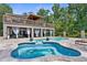 Beautiful pool and spa area with brick pavers and elegant white curtains at 12085 Stringer Rd, Brooksville, FL 34601