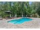 Backyard pool and spa surrounded by stone pavers, professional landscaping, and privacy fence at 12085 Stringer Rd, Brooksville, FL 34601