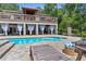 Outdoor pool area featuring lounge chairs and a luxurious, covered patio at 12085 Stringer Rd, Brooksville, FL 34601