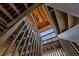 Unique staircase with wooden railings and exposed ceiling beams, creating a rustic charm at 12085 Stringer Rd, Brooksville, FL 34601