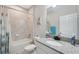 Well-lit bathroom with shower-tub combo, granite vanity, and white fixtures that add a touch of luxury at 12313 Criollo Rd, Spring Hill, FL 34610