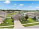 Beautiful home exterior with a well-manicured lawn, mature landscaping, and a serene lake view at 12313 Criollo Rd, Spring Hill, FL 34610