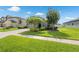 Inviting curb appeal with lush green lawn, mature landscaping, and a well-maintained home exterior at 12313 Criollo Rd, Spring Hill, FL 34610