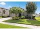 Beautifully landscaped front yard with mature trees, green lawn, and a welcoming facade at 12313 Criollo Rd, Spring Hill, FL 34610