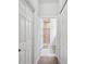 Hallway view into main bathroom shows tile shower, tile flooring, and vanity at 12313 Criollo Rd, Spring Hill, FL 34610