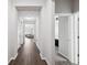 Bright hallway with wood floors leading to the living area and bedrooms at 12313 Criollo Rd, Spring Hill, FL 34610