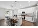 Bright kitchen features stainless appliances, subway tile backsplash, granite countertops, and large island with bar seating at 12313 Criollo Rd, Spring Hill, FL 34610