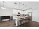 Contemporary kitchen with a granite island, white cabinetry, and modern stainless steel appliances at 12313 Criollo Rd, Spring Hill, FL 34610