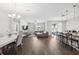 Spacious living area and dining area featuring modern lighting fixtures and barstool seating at 12313 Criollo Rd, Spring Hill, FL 34610