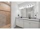 Bright main bathroom boasts double vanity, granite countertops, tile flooring, and tile shower at 12313 Criollo Rd, Spring Hill, FL 34610