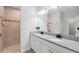 Bright main bathroom features double vanity, granite countertops, tile flooring, and tiled shower at 12313 Criollo Rd, Spring Hill, FL 34610
