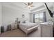 Calm main bedroom boasts trey ceiling, ceiling fan, and neutral decor with ensuite bathroom access at 12313 Criollo Rd, Spring Hill, FL 34610