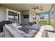 Spacious covered patio complete with stylish furnishings, ceiling fans, and a view of the beautiful backyard at 12313 Criollo Rd, Spring Hill, FL 34610